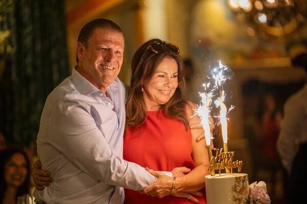 Sean Bean and Julie Graham at an anniversary celebration with a cake and sparklers.