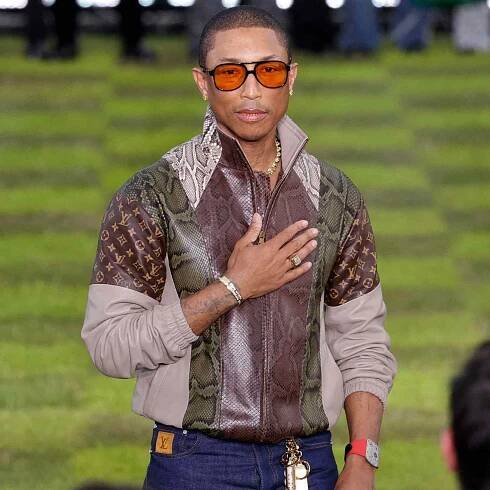 Pharrell Williams (C) acknowledges applause after presenting creations for the Louis Vuitton Mens Ready-to-wear Spring/Summer 2025 collection as part of Paris Fashion Week