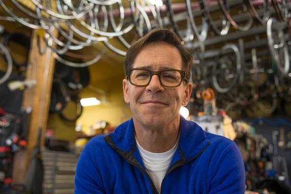 Brand photography of a bike shop owner. Commercial portrait.