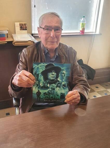 Michael McStay holding a signed Doctor Who print.