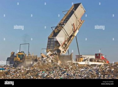 Tipper dumping semi trailer containing trash. Stock Photo