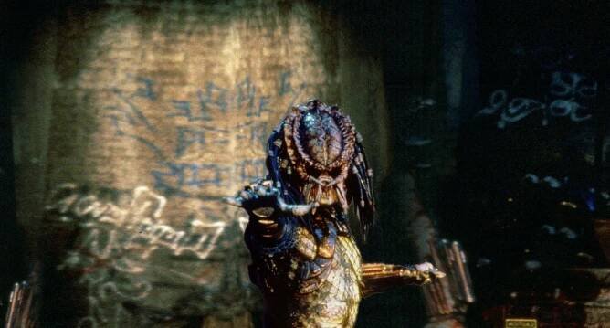 The predator standing next to a wall in the movie "Predator 2"
