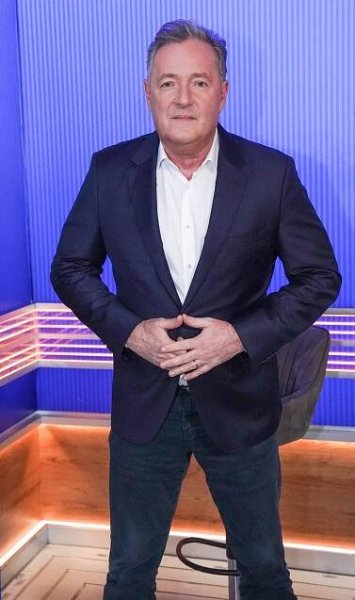 Piers Morgan in a navy blazer and jeans.