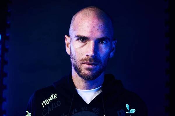 a bald man in a hoodie with neon lights Wallpaper