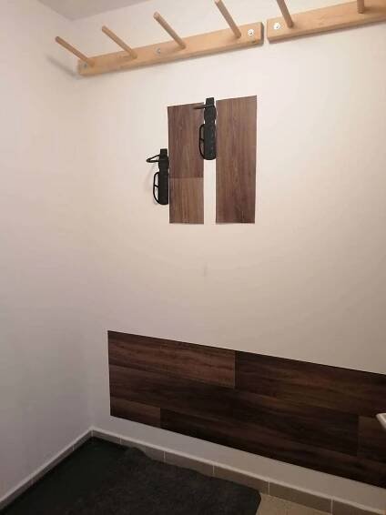 a room with a wall with two lights on the wall at Apartmán u Tesáka - Říčky v Orlických horách in Říčky