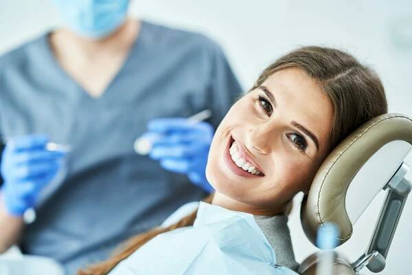 Male dentist and woman in dentist office