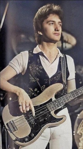 a young man is playing an electric guitar