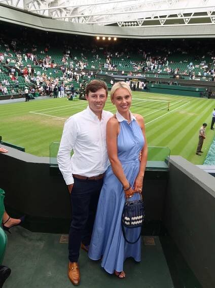 Couple at Wimbledon tennis match.