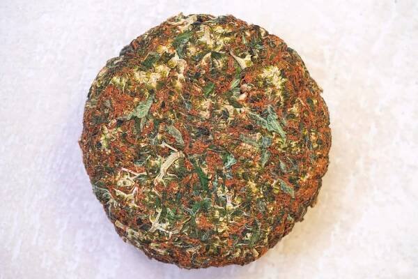 Brick cannabis on a white surface