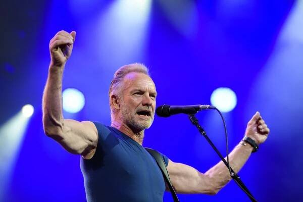Sting performing on stage.