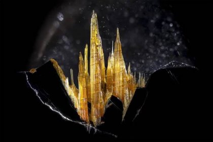 A close image of sharp crystals jutting up from darker material