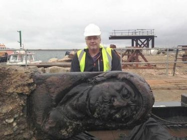 Archaeologist Dave Parham with the elaborately carved rudder 