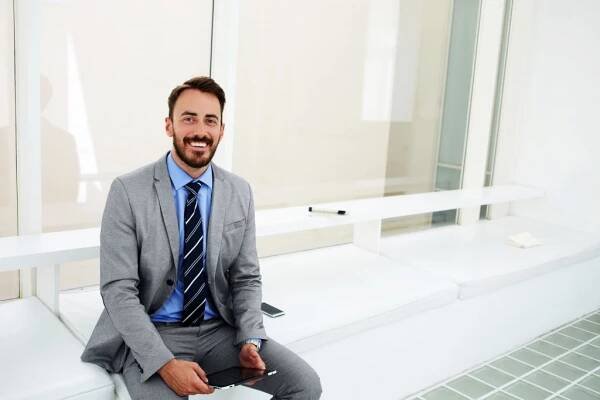 young businessman smiling employee engagement realized worth