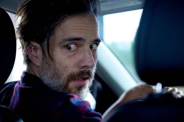 Mitch Valmy (Kristopher Turner) glances behind him frightened in a car on SurrealEstate Season 3 Episode 2 "Night Terrors".