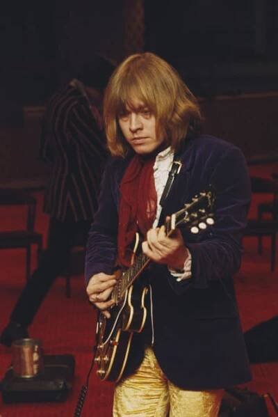 Brian Jones playing guitar, looking tired