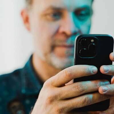 Man looking at mobile phone.
