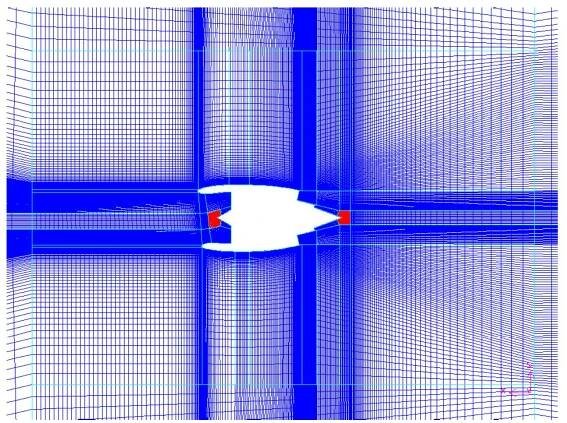 Figure 6.3 Mesh at the symmetry plane. The areas filled with red colour are where an unstructured mesh was used. 