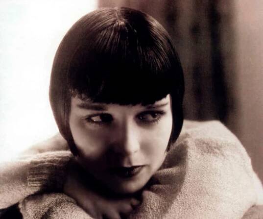 Grayscale Portrait Photo of the actress Louise Brooks, wearing big white scarf