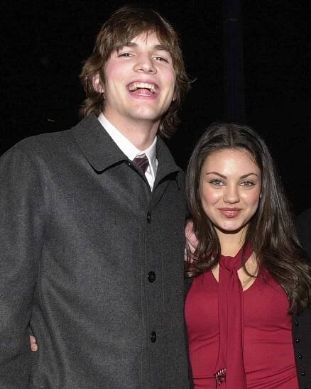  Ashton Kutcher and Mila Kunis posing for a photo in 2000