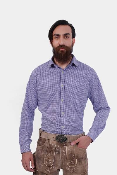 A man wearing the Christian Friedel Lederhosen Shirt, a purple and white checkered long-sleeve shirt with a front pocket. He pairs it with light brown leather Lederhosen that are intricately embroidered and include a decorative belt buckle. This ensemble is ideal for Oktoberfest and other traditional Bavarian events, offering a blend of modern comfort and classic style.