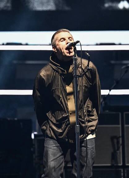 Liam Gallagher of Oasis performing on stage.
