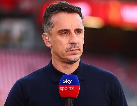 Gary Neville speaking into a Sky Sports microphone.