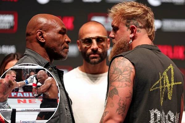 Mike Tyson (black gloves) fights Jake Paul (silver gloves) at AT&T Stadium. 