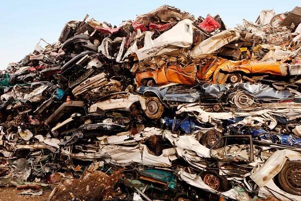 Stack of crushed cars at junkyard