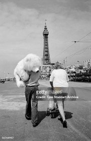 Family enjoying their holiday on Blackpool's Golden Mile. Blackpool is the most popular coastal resort in the UK and has been attracting millions of...