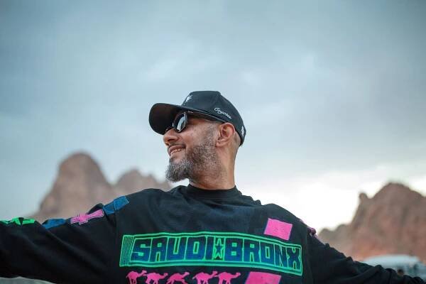 The hip-hop producer Kasseem Dean, known as Swiss Beatz, wearing a black shirt with the words “Saudi Bronx” displayed on it.