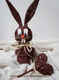 an easter bunny made out of wicker sitting on a blanket