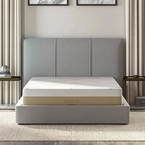 Saatva Contour5 Mattress on a gray bed frame against cream walls. 