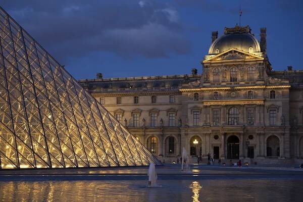 View of large museum with triangular glass sculpture placed in front