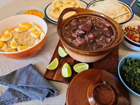 Delectable Brazilian Feijoada with flavorful garnishings Wallpaper