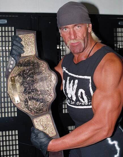 Hulk Hogan holding a championship belt.