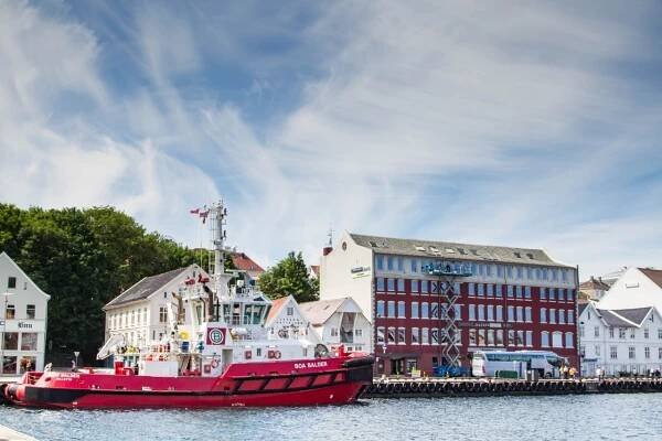 A red boat docked in Stavanger, Norway.