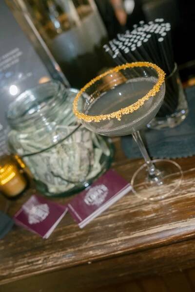 Close Up of Cocktail at Wedding Cocktail Bar Next to Tip Jar 