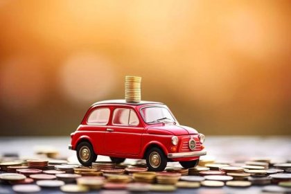 Red car on coins. Car insurance and car loans, concept of savings money on car purchase