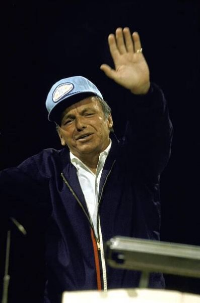 Frank Sinatra waved at the camera during a rehearsal for a benefit concert, 1971.