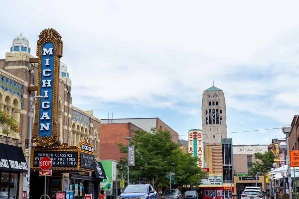Theater buildings with Michigan and State signs on a busy street in Ann Arbor, Michigan