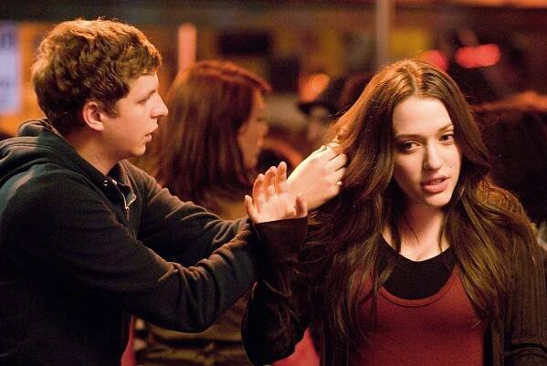 Michael Cera fixing Kat Dennings’ hair.