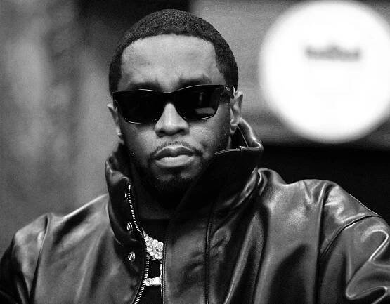 Image may contain Sean Combs Clothing Coat Jacket Face Head Person Photography Portrait Accessories and Sunglasses