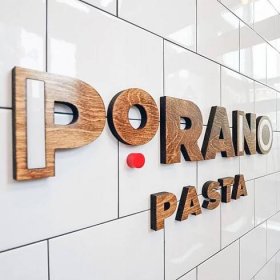 Porano Pasta dark wood and colored wood restaurant  wall sign on white tile