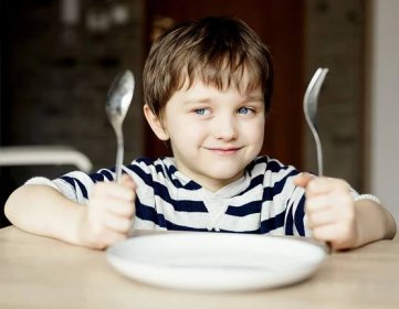 Happy little boy waiting for dinner. | Kidstir