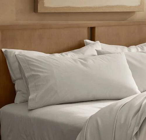 Close up lifestyle image of bed made with Signature Vintage Washed Pillowcase Set in Mist