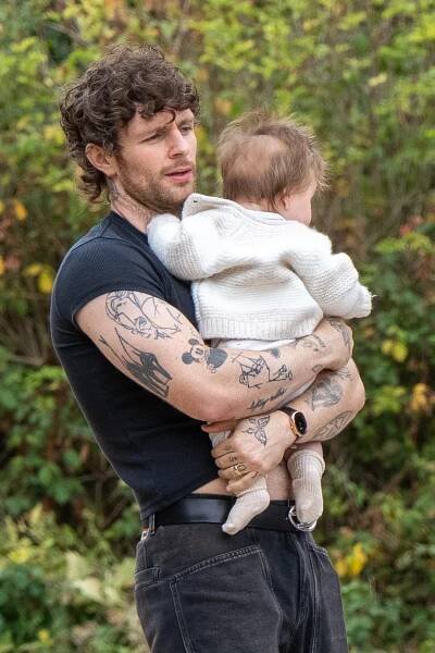 Tom Grennan holding his baby.