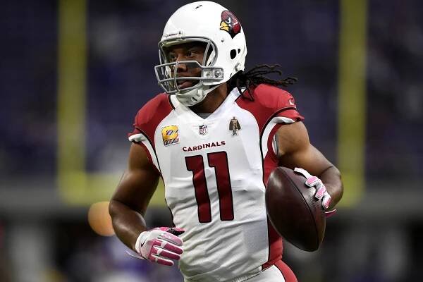 Larry Fitzgerald warms up on field before the game last season.
