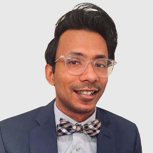 Ather is smiling against a gray background.