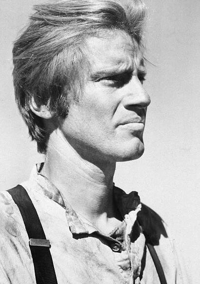 Profile shot of Sam Shepard, wearing a shirt and suspenders