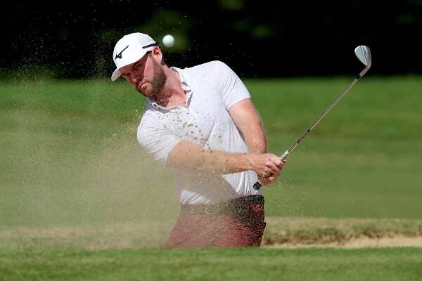Grayson Murray of the United States plays a shot from a bunker on the ninth hole during the final round of the Sony Open in Hawaii at Waialae Country Club.
